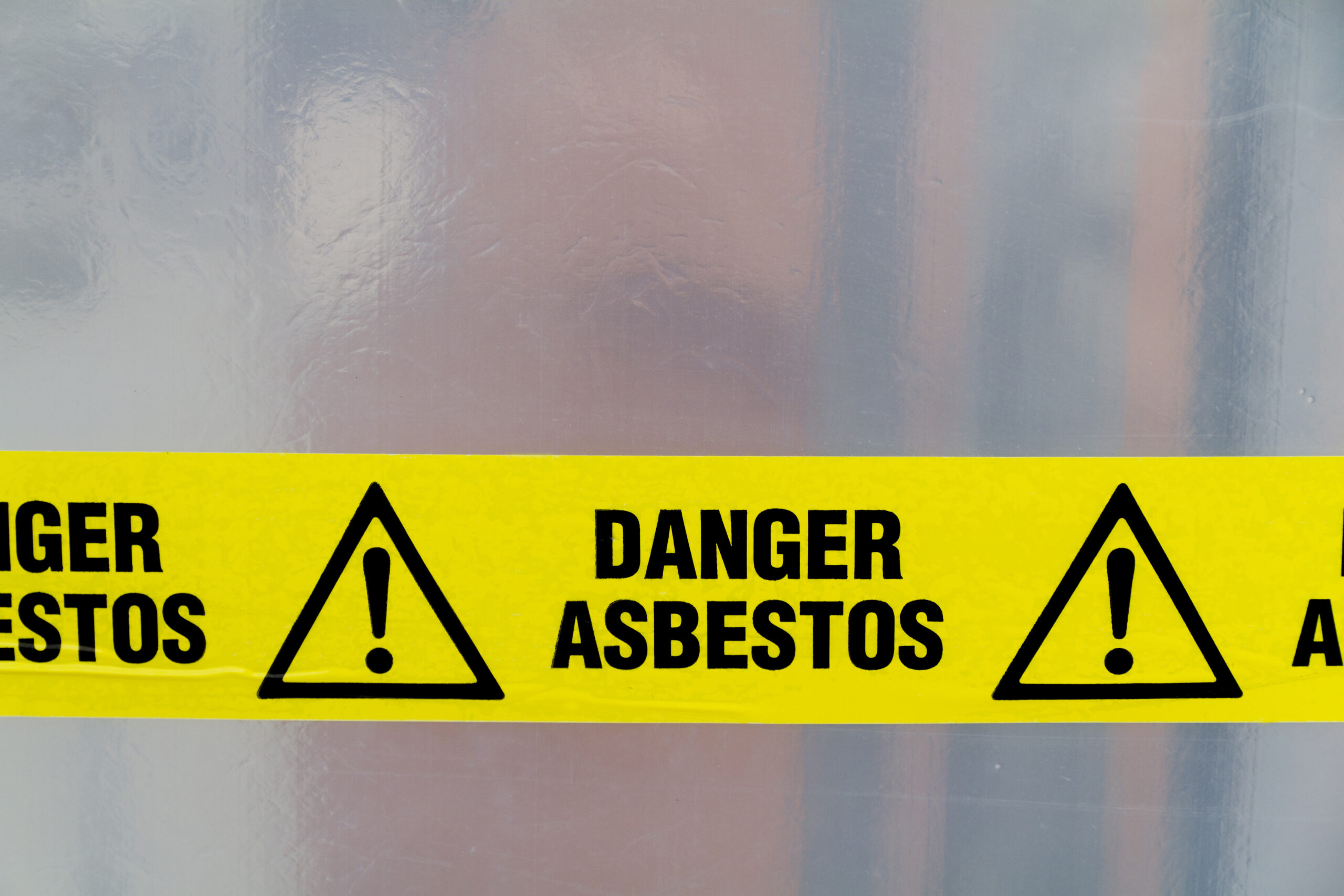 close up of a danger asbestos yellow warning tape