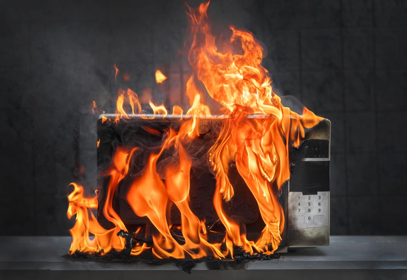 microwave oven white, in fire front view, electrical appliances caught fire as a result of improper operation